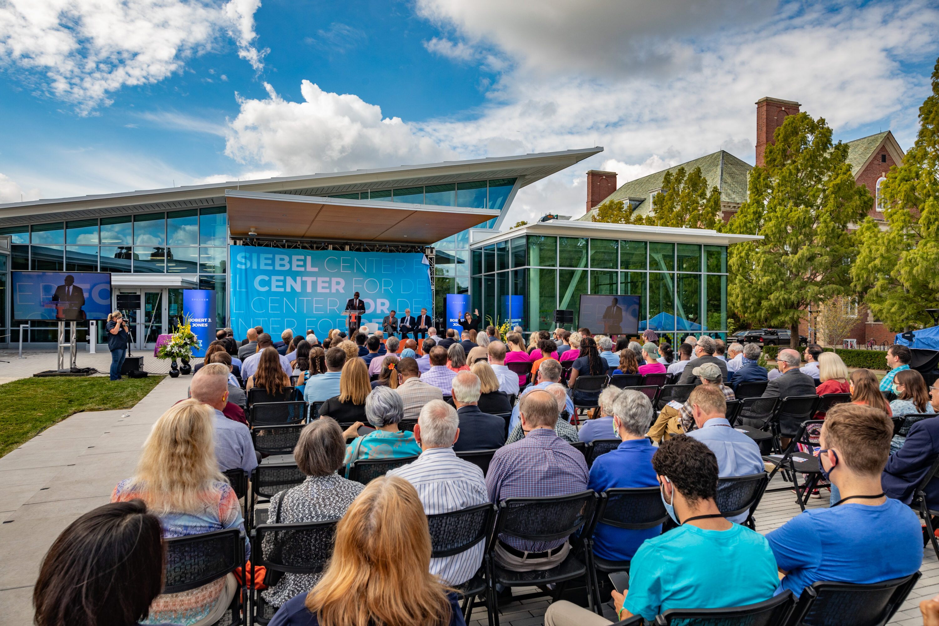 Guest of honor Tom Siebel joins dignitaries during building dedication ceremonies for the Siebel Center for Design.
Remarks were given by Siebel Center for Design’s director, Rachel Switzky, plus University of Illinois System President Timothy Killeen, UIUC Chancellor Robert Jones, and UIUC Provost Andreas Cangellaris. Tom Siebel delivered keynote remarks.
Following the ceremony, guests toured the center during open house festivities.
Thomas M. Siebel is the founder of C3 AI and has served as the chairman of the board of directors since January 2009 and as chief executive officer since July 2011. Prior to founding the company, Siebel founded and served as the chief executive officer of Siebel Systems, a global CRM software company, from 1993 until it merged with Oracle Corporation in January 2006. Siebel served in various leadership positions with Oracle Corporation from January 1984 to September 1990. Siebel serves as a member of the boards of advisors for the colleges of engineering at the University of Illinois Urbana-Champaign and the University of California, Berkeley.